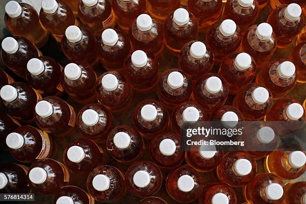 Bottles of labeled cow urine sit on the ground at a processing facility in Greater Noida, Uttar Pradesh, India, on Friday, June 17, 2016. Urine from...