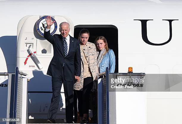 Vice President Joe Biden waves as he arrives in Sydney with his granddaughters Niomi, center, and Finnegn on July 18, 2016 in Sydney, Australia....
