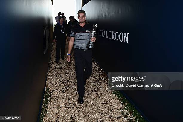 Henrik Stenson of Sweden walks with the Claret Jug following his victory during the final round on day four of the 145th Open Championship at Royal...
