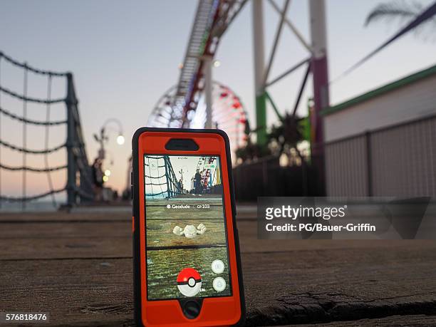 Pokemon Go players are seen in search of Pokemon and other in game items at the Santa Monica Pier on July 17, 2016 in Los Angeles, California.