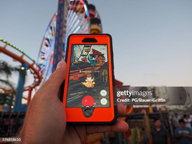 Pokemon Go players are seen in search of Pokemon and other in game items at the Santa Monica Pier on July 17, 2016 in Los Angeles, California.