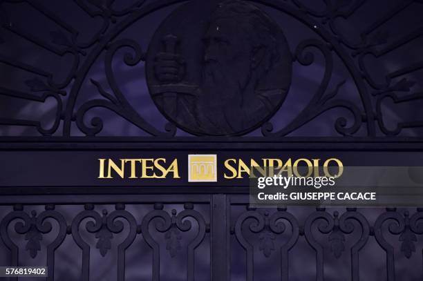 Picture taken on July 17, 2016 shows the logo of the Intesa SanPaolo bank at the headquarters in Turin, in the Italian region of Piemonte. - A cloud...