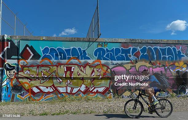 Cyclist passes near the mural in McCauley area, a vibrant and ethnically diverse inner city neighbourhood in Edmonton. On Tuesday 12 July 2016, in...