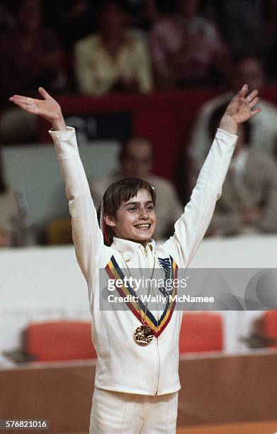 Nadia Comaneci with one of the three gold medals she won at the Montreal Olympics, July 1976.