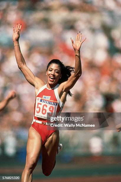 Track and field runner Florence Griffith Joyner waves to the sky as she wins the 100 meter dash at the 1988 Olympics in Seoul, Korea.
