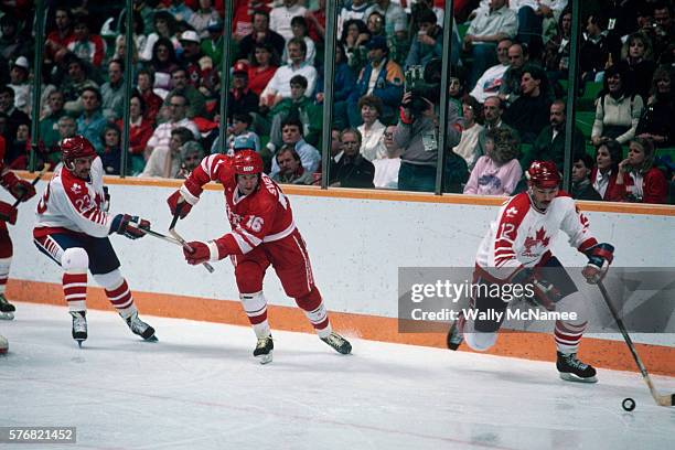 Canadian ice hockey player moves the puck down the ice during a game between the USSR and Canada at the 1988 Olympic Winter Games in Calgary.