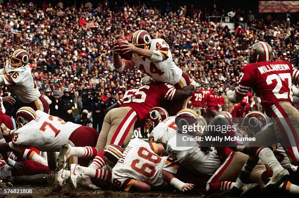 Washington Redskins running back John Riggins leaps over the defense to score a touchdown during the NFC Championship game against the San Francisco...
