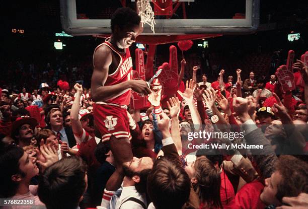 Isaiah Thomas cuts the basketball net from the hoop after Indiana University's victory in the NCAA Final Four.