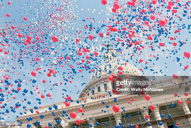 red, white, and blue balloons over the u.s. capitol building - american politics ストックフォトと画像
