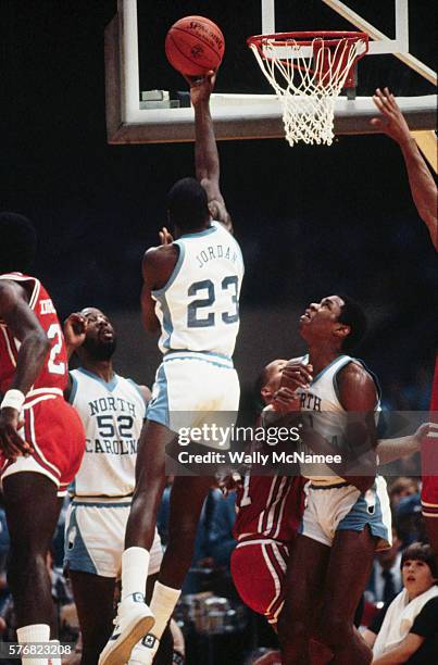 Basketball phenom Michael Jordan drives toward the basket in his team's semifinal match against Houston. NC won and went on to win the title. Also in...