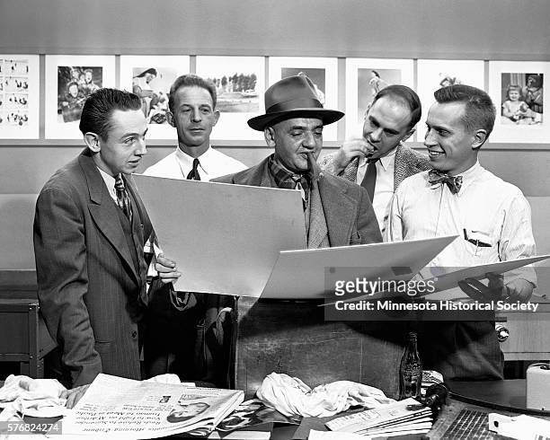 Arthur "Weegee" Felling, the famous New York City crime photographer , visits colleagues in Minneapolis.