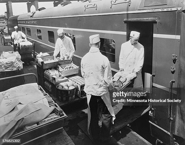 Food Service Men Stock Dining Car at Commissary
