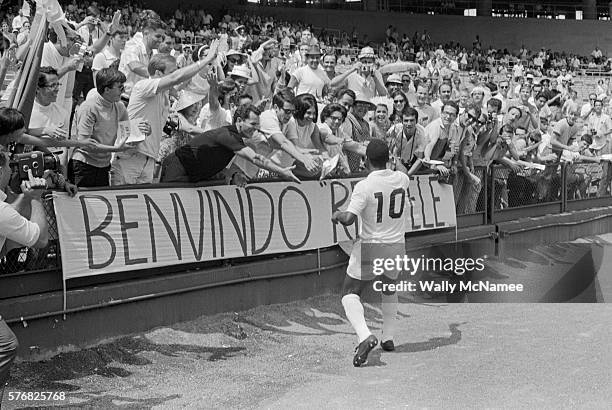 Pele, the most popular athlete in the world in his era, declared a "National Treasure" by Brazil, greets fans after a soccer match at RFK Stadium in...