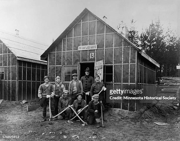 Road workers pose proudly in their camp in Kenora, Ontario, in 1931. They cleared a stretch of highway in Ontario that would later be a link in the...