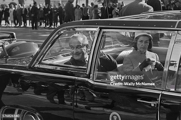 President Lyndon Johnson and wife, Ladybird, leave Blair House in the Presidential limousine after participating in welcoming ceremonies with Mexican...