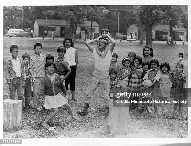 The children of Mexican-American migrant farm workers play together at a farm in Minnesota.