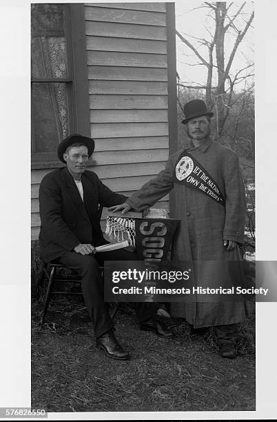 Two Socialist men in Sioux Agency Township, Minnesota, display political pennants.