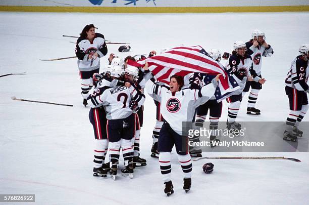 Members of the US women's ice hockey team celebrate after the final game at the 1998 Winter Olympics. The Americans won the gold medal by defeating...