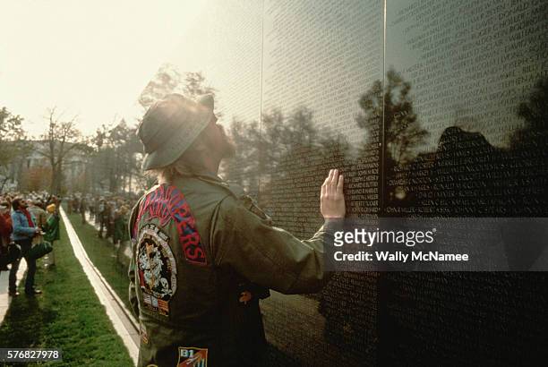 Survivor of The War In Vietnam searches "the wall" for the name of a fallen comrade in the days preceding the dedication of The Vietnam Veterans...