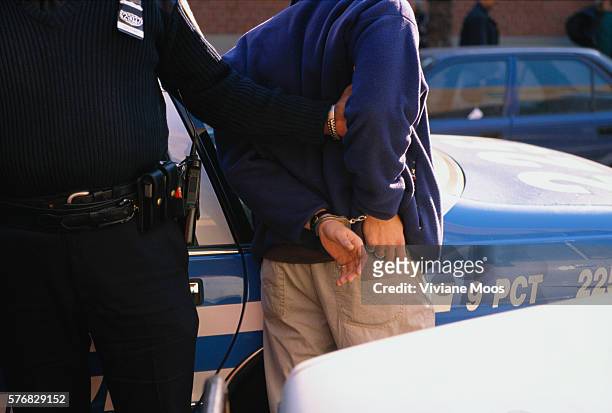 Police Officer Handcuffs and Arrests a Suspect