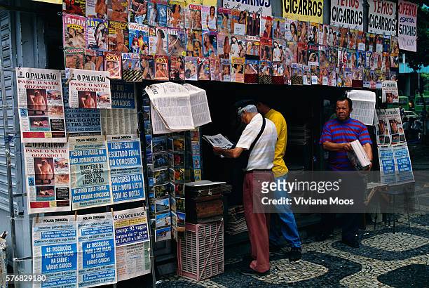 Pedestrians Browsing at a Newsstand