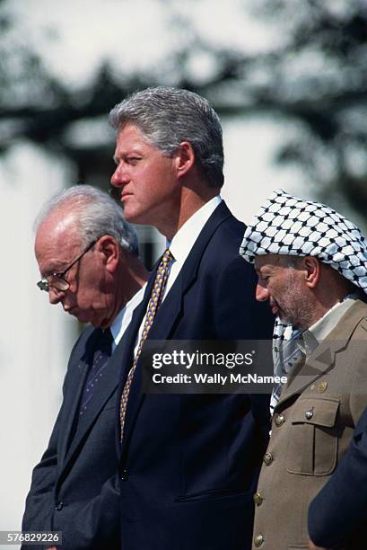 American President Bill Clinton stands between Yitzhak Rabin and Yasir Arafat during the signing of the Israeli-Palestinian Peace Agreement on the...