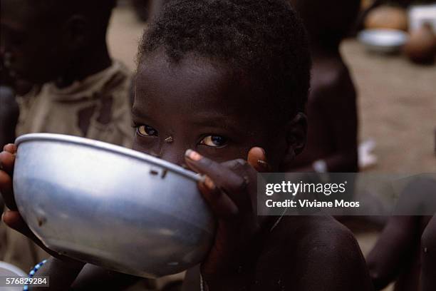 Child eats at a feeding center in Kongor, Sudan.