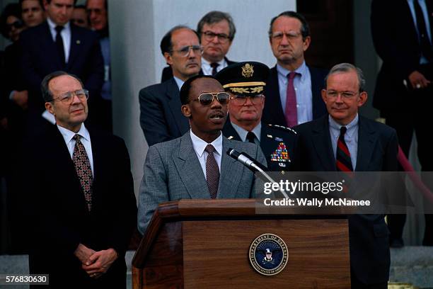 Jean-Bertrand Aristide speaks outside the Pentagon with American Defense officials, including from left Secretary of Defense William Perry, Joint...