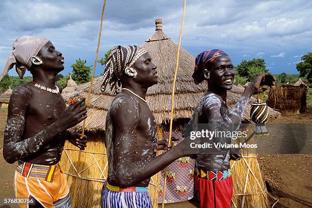 Men perform a traditional dance as warriors and suitors during a wedding at a refugee camp in southern Sudan. Civil war and widespread famine have...