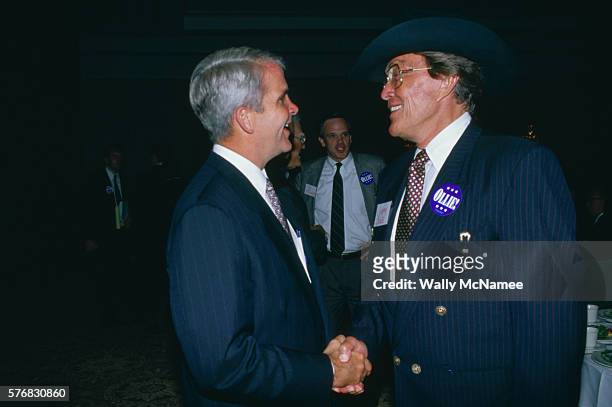 Former country-western singer now turned entrepreneur in the food business, Jimmy Dean, shakes hands with Oliver North at a fundraising event in...