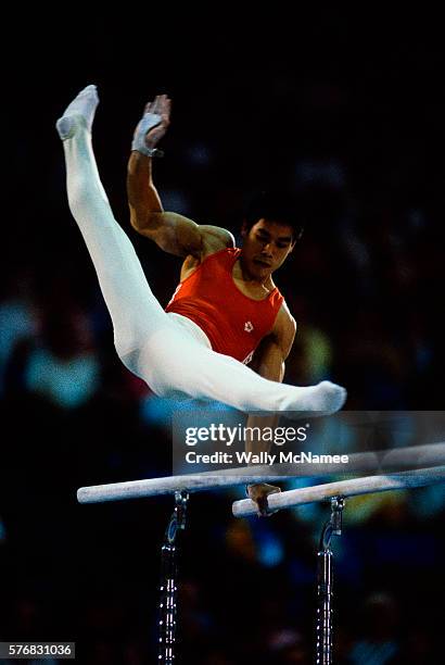 People's Republic of China star gymnist Ning Li careens above the parallel bars during team gymnastics competition at the 1984 Summer Olympic Games...