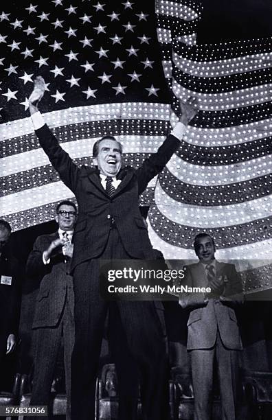 President Richard M. Nixon waves his arms to a crowd of supporters prior to his speech at a convention in Washington, DC. The President is speaking...