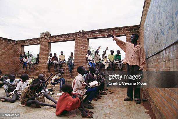 Children in the refugee camp of Ame, Sudan, must attend school in a building almost completely destroyed by bombs. Civil war and widespread famine...