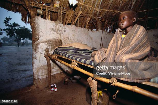 Young patient at the hospital in Ame, Sudan, suffers from malnutrition and malaria. Civil war and widespread famine have ravaged Sudan for decades,...