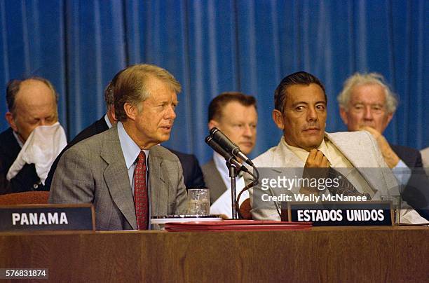 President Carter and Panamanian dictator Omar Torrijos Herrera prepare to sign the Panama Canal Treaty. The agreement will hand over the Panama Canal...