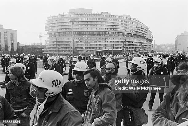 Officers from the Washington, DC, Metropolitan Police Civil Disturbance Unit arrest anti-war demonstrators near the Watergate complex. Students from...