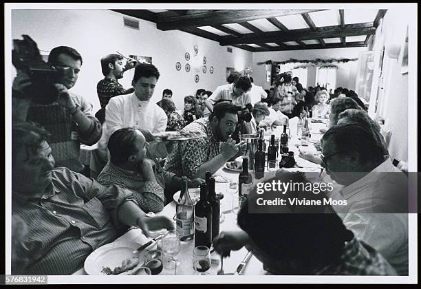 Camera Operator Filming Large Dinner Party