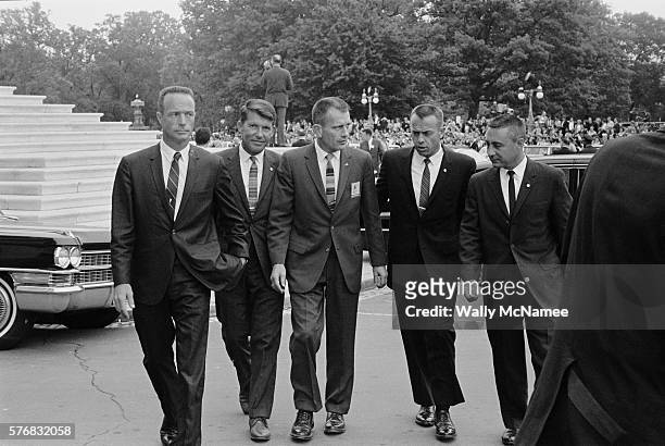 Five of the original seven Mercury astronauts walk across the Capitol Plaza during a celebratory visit to Washington, DC. From left to right: Scott...