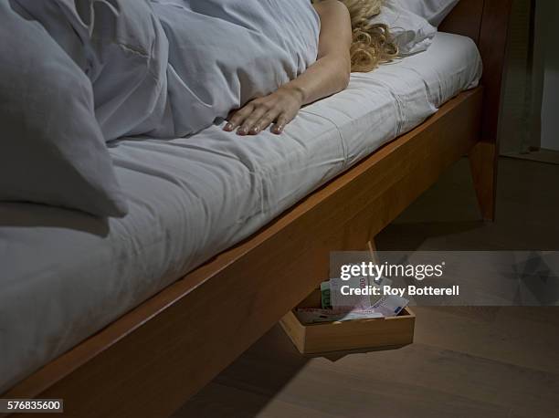 box with euro bills under young woman's bed - money under the bed bildbanksfoton och bilder