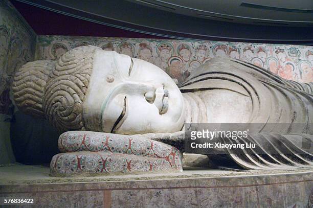 statue of sleeping buddha in mogao caves - mogao caves stock pictures, royalty-free photos & images