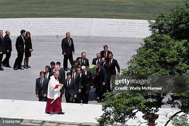 John F. Kennedy Jr. And Caroline Kennedy Schlossberg walk behind the pall bearers during the funeral for their mother, Jacqueline Bouvier Kennedy...