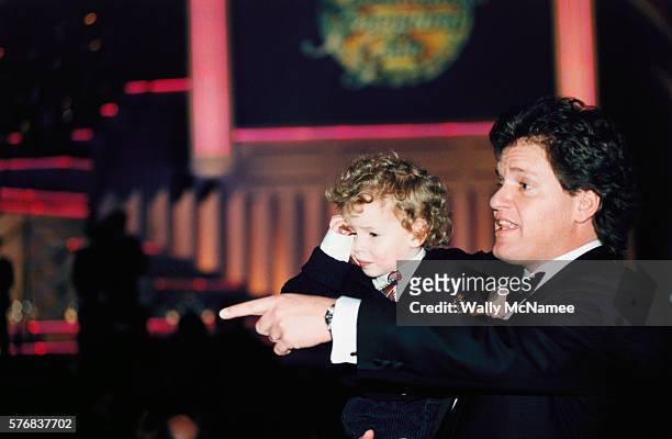 Roger Clinton, half-brother of President Bill Clinton, holds his son, Tyler, at the Presidential Inaugural Gala.