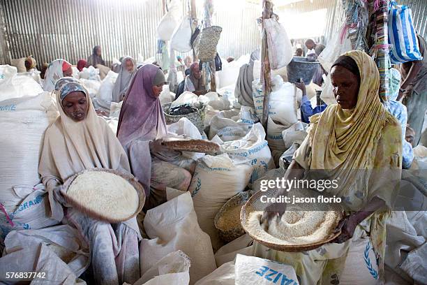 Women sifting maize for distribution to food kitchens in Mogadishu by the Non Government Organization SAACID, with maize donated by World Food...