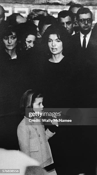 Jacqueline Kennedy holds the hand of daughter, Caroline, during the memorial service of her late husband, President John F. Kennedy.