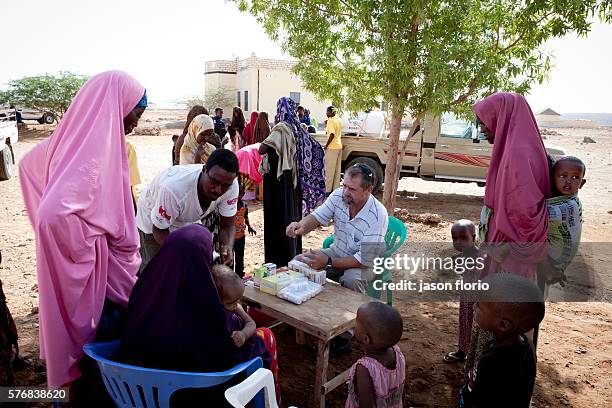 White South African doctor treating women and children near Bosaso, Somalia.