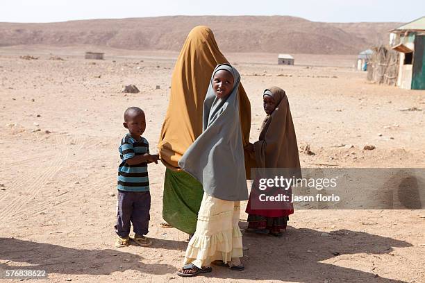 Somalia mother and her children in the desert near Bossaso,in the Puntland region, Somalia.