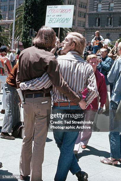Homosexual couple hold each other during the first gay rally. Union Square, San Fransico. Ca. 1960s.
