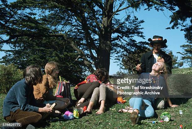 Man paints a woman's face during the Summer of Love in Haight Ashbury, San Francisco, California. 1967.