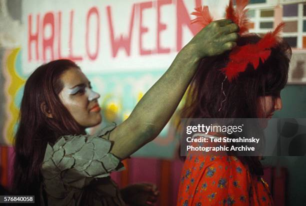 Two women prepare for the Acid Test Graduation, , a celebration organized by Ken Kesey and his Merry Pranksters, in which participants graduated...