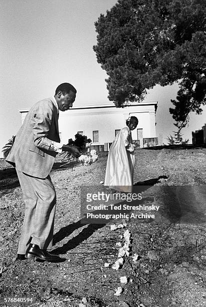 Couple who lost close relatives in the Jonestown massacre place flowers on their graves. October 1979, Oakland, California, USA.